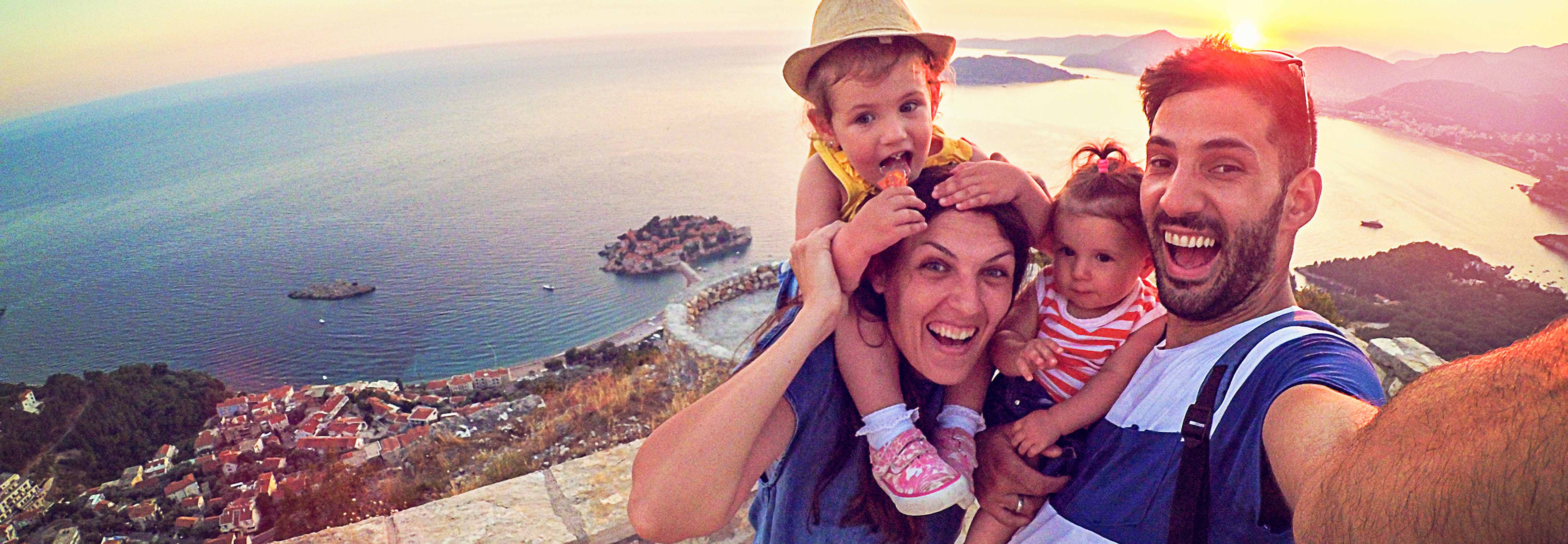 Two children and parents take a selfie while on holidays