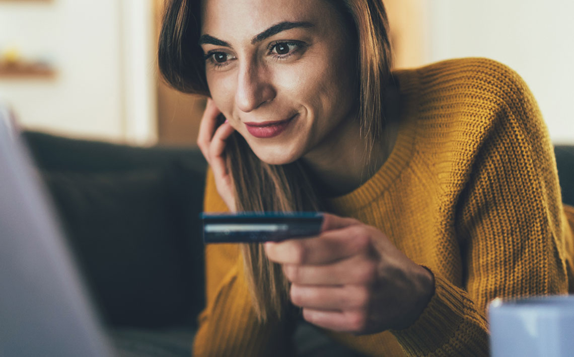 Woman looking up benefits of An Post Money Credit Card