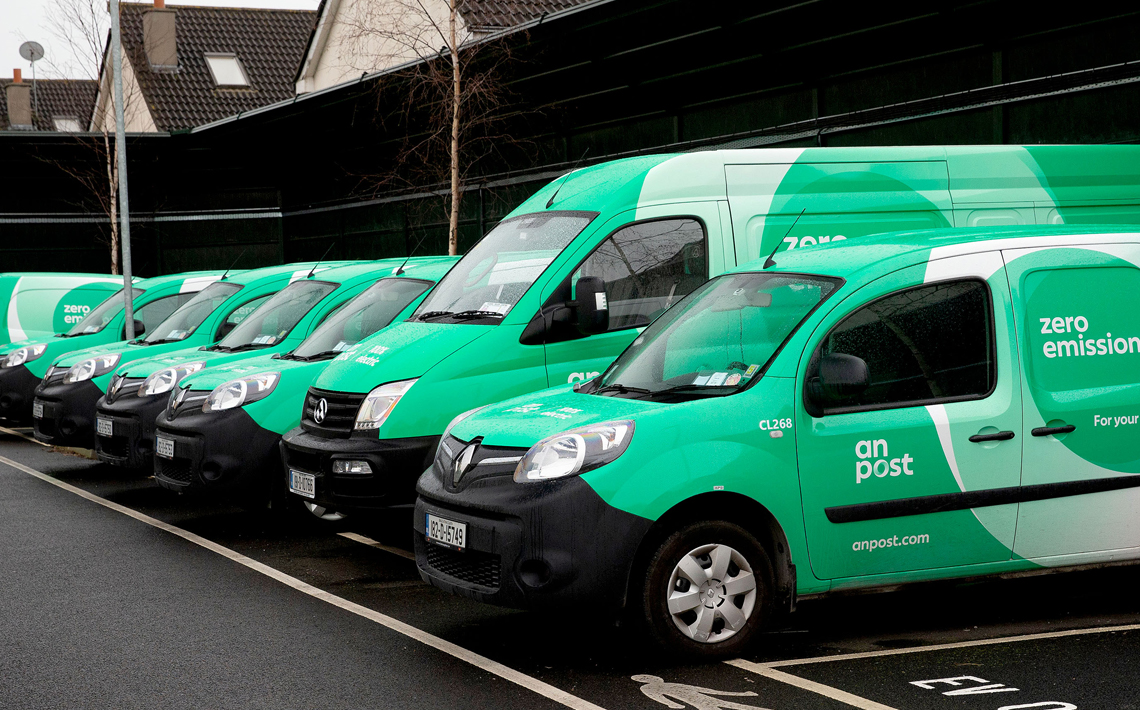 Line up of parked An Post zero emission vehicles