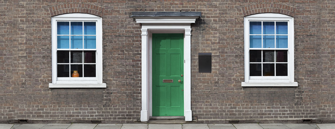 A green door in a brick building