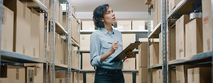 Women and man looking at clothes from a box