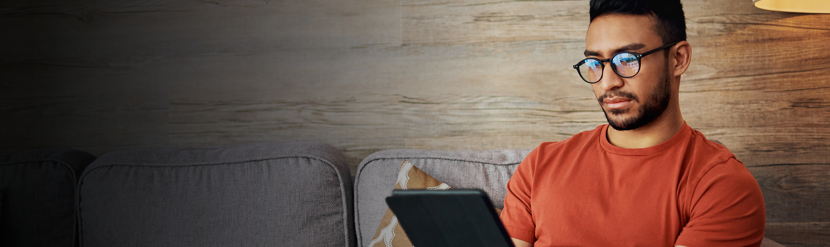 Man downloading delivery label on his tablet to send a parce