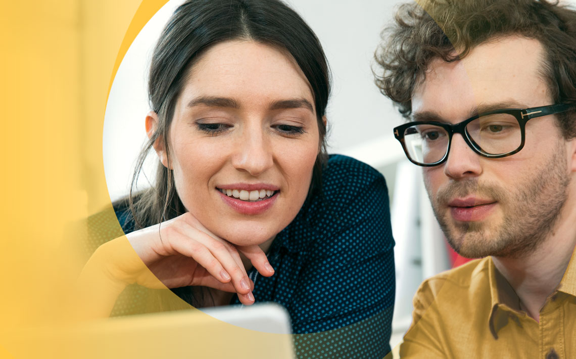 man and woman looking at laptop