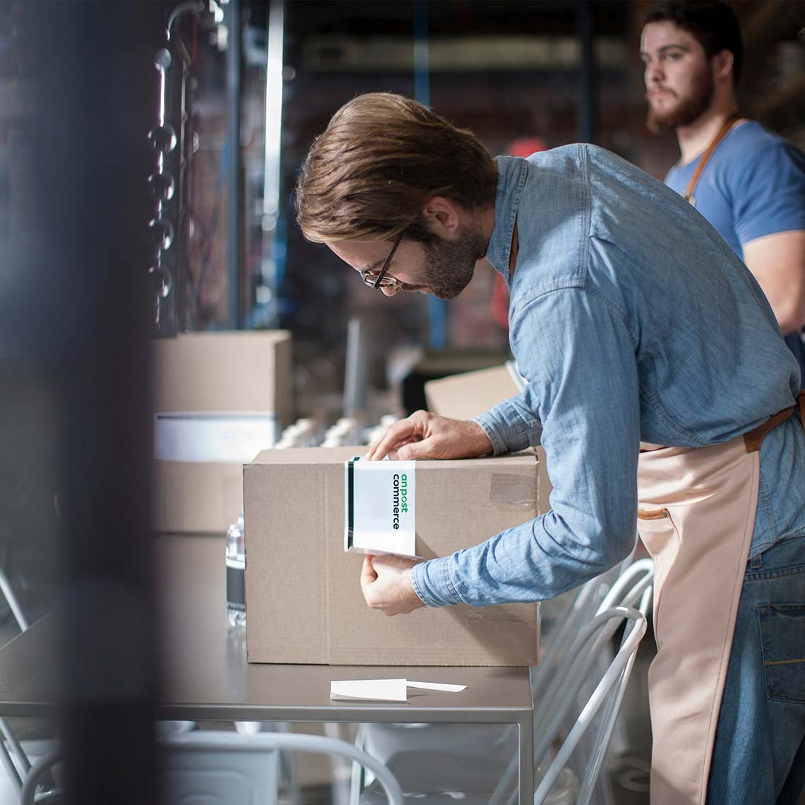 Man putting postage label on a box