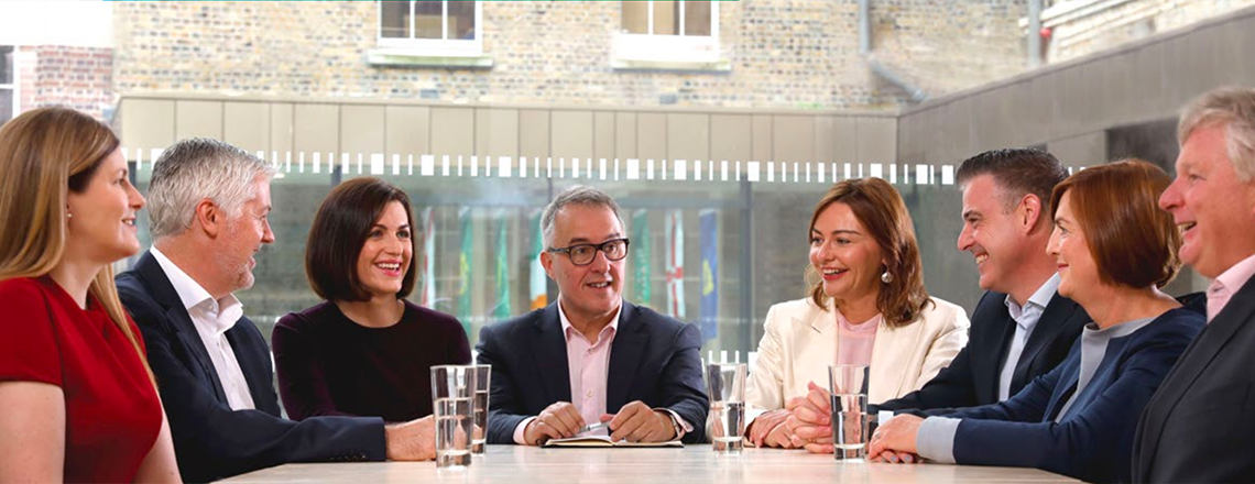 Senior An Post staff members around a boardroom table.