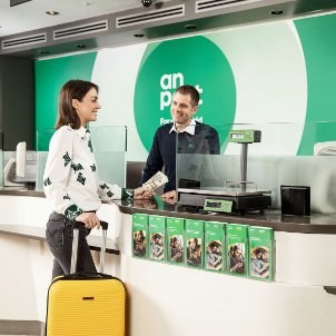 Woman with suitcase in post office 