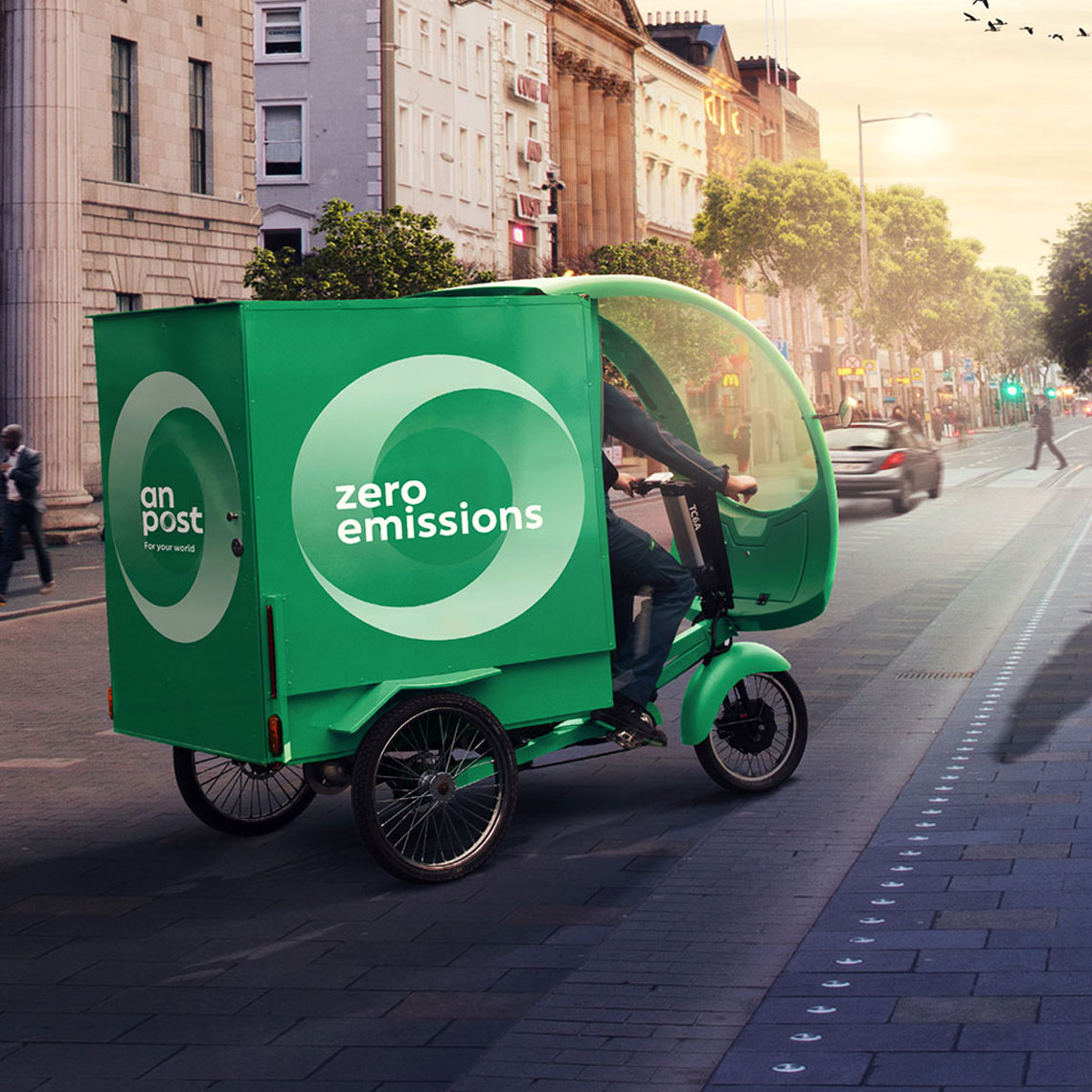 An Post branded tricycle cycling past GPO