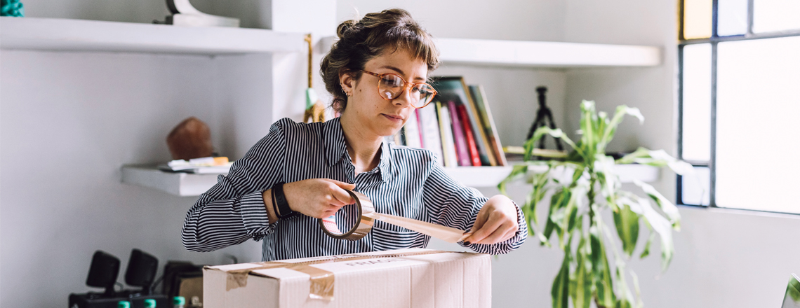 Woman taping up a parcel