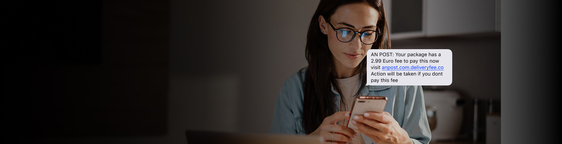 Woman looking at her phone after receiving a scam text.