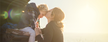 Mother kisses son on forehead