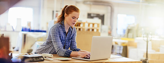 Woman on laptop at workstation